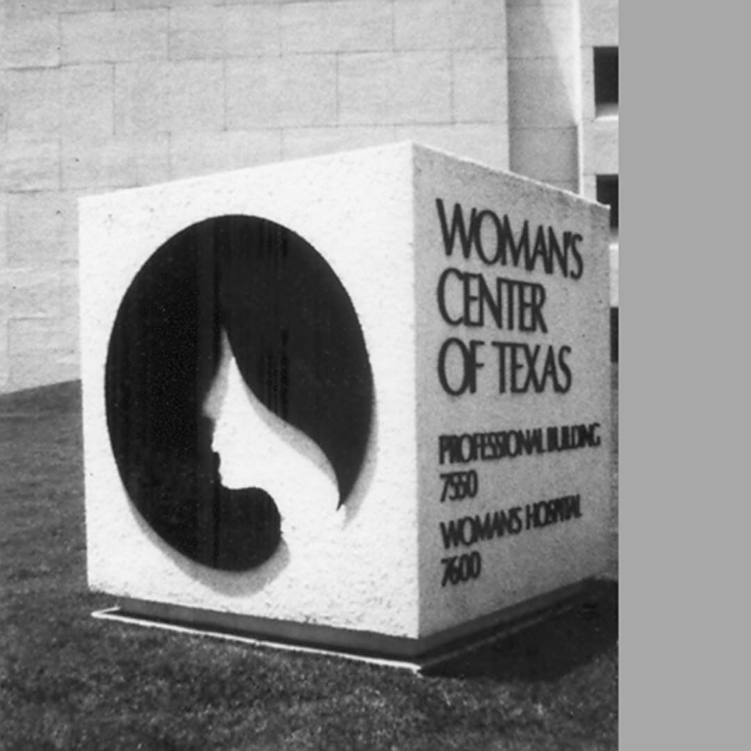 White block with womans center of texas in black
