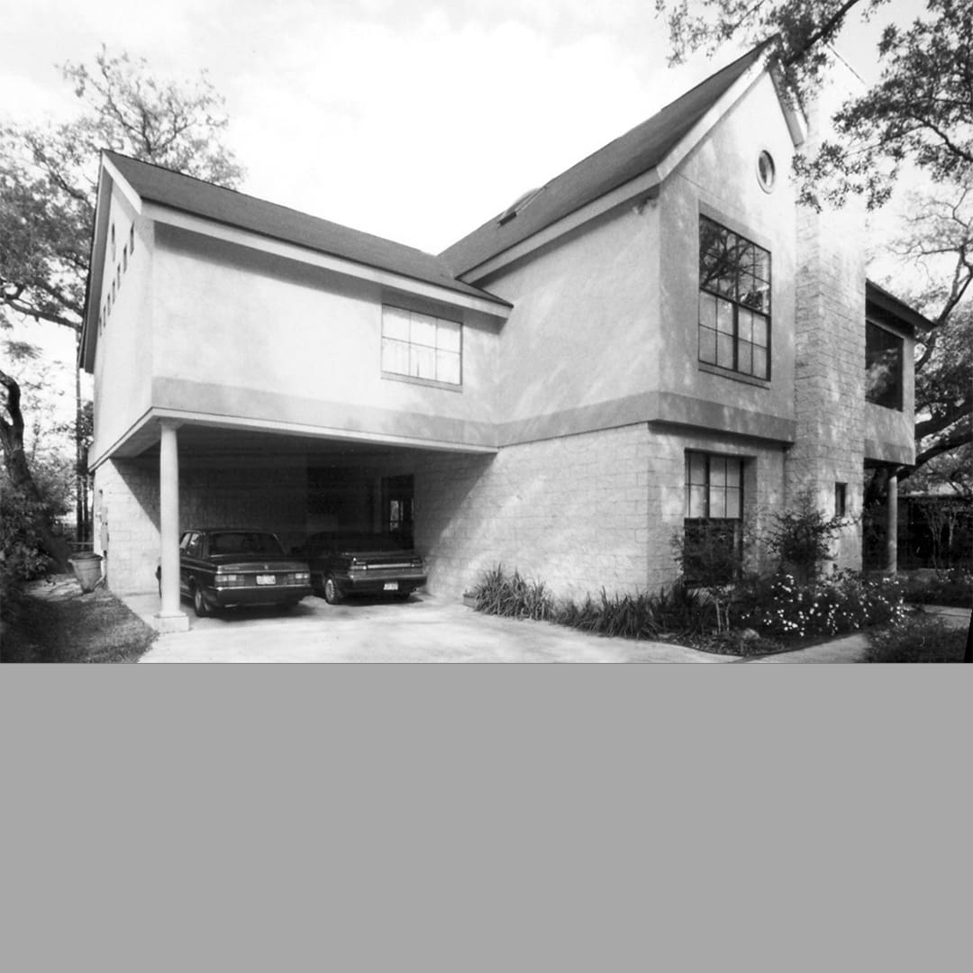 Black and white view of the building with cars parked
